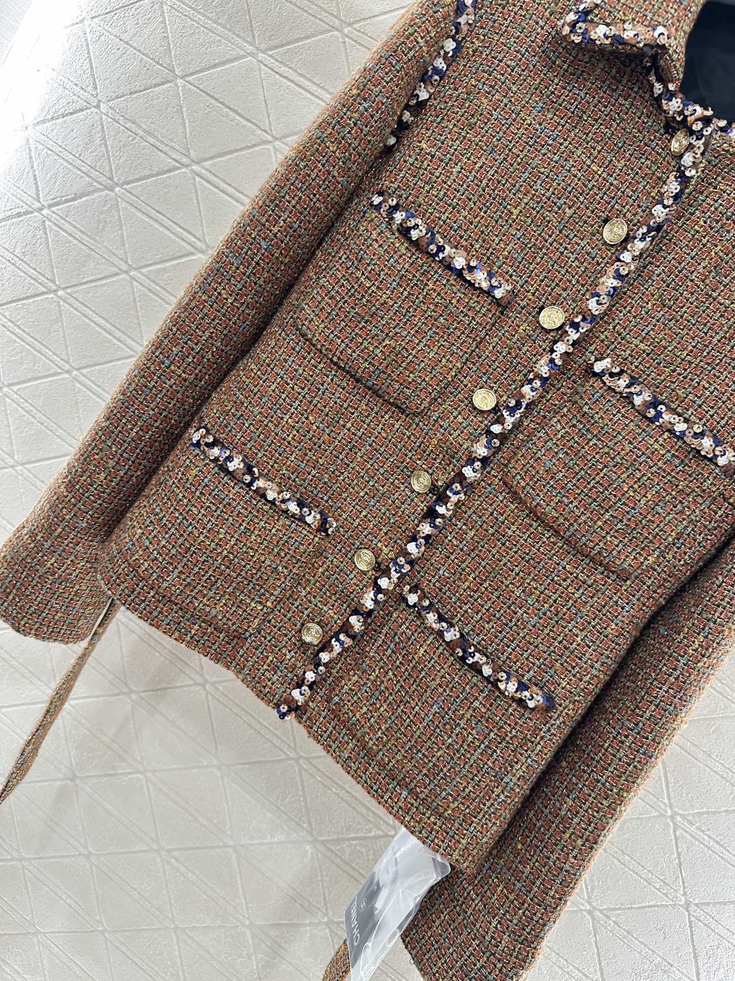 Lapel and belted dress jacket with beaded hem
