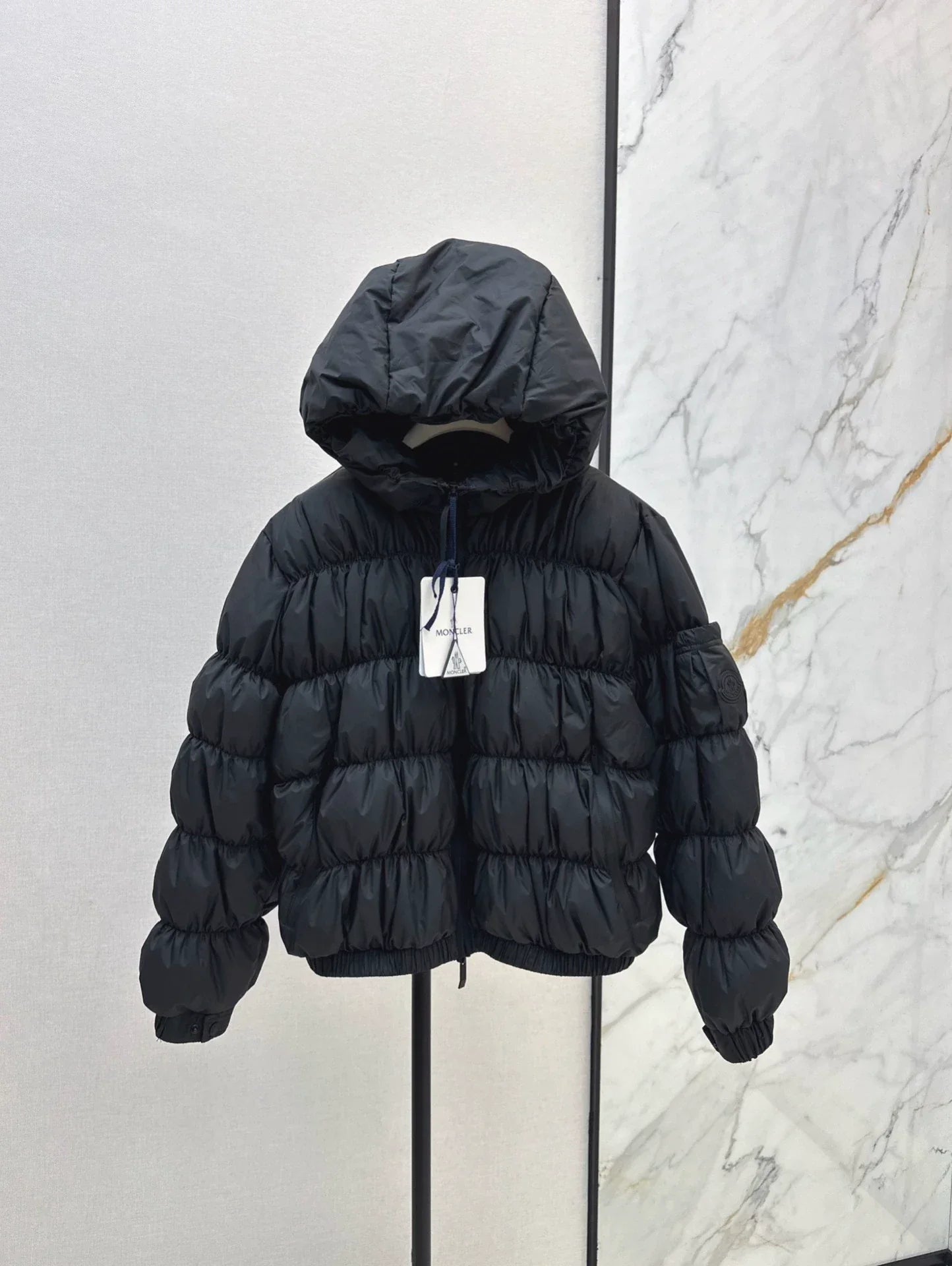 25 Pleated decorative hooded down jacket