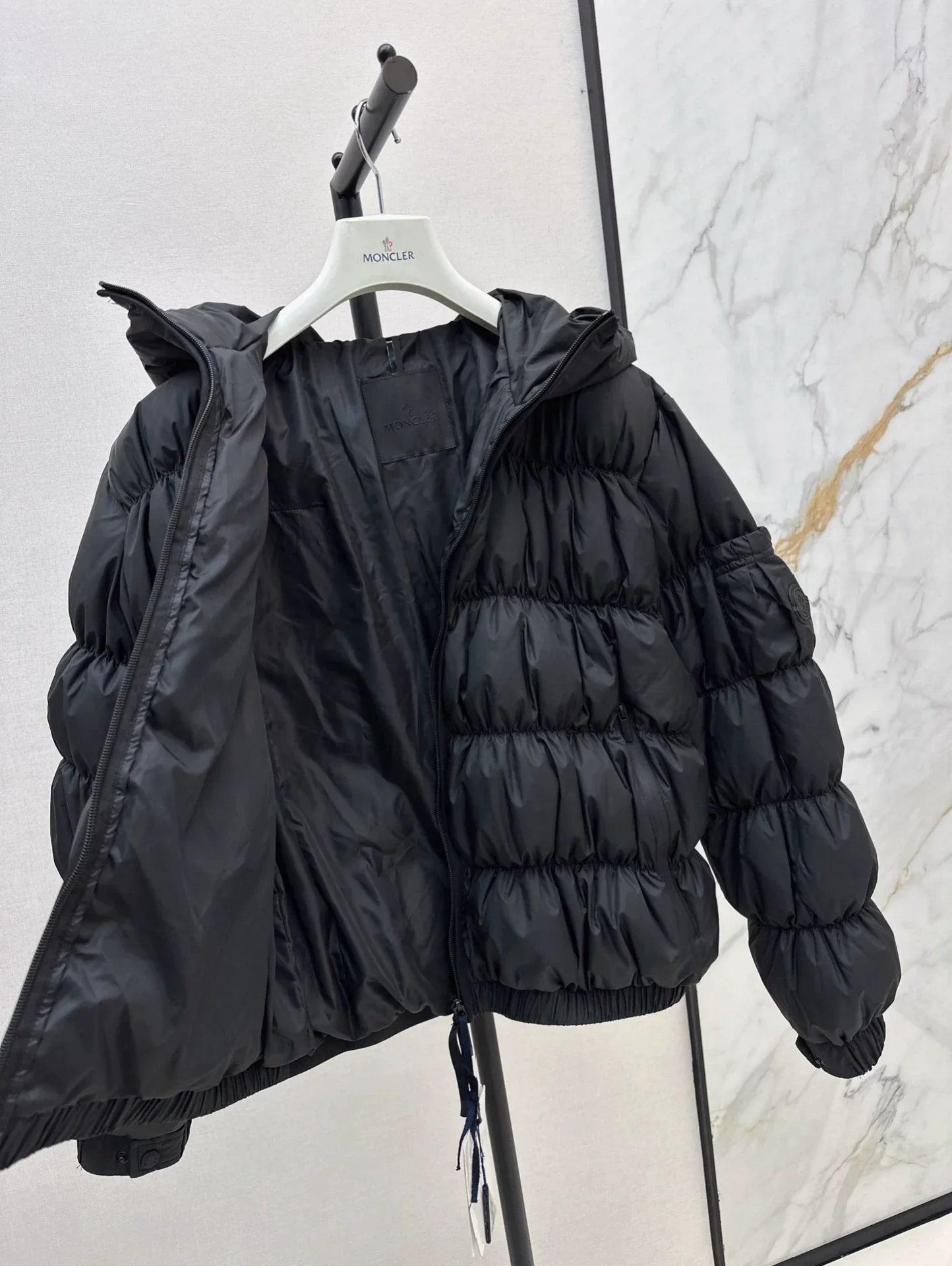 25 Pleated decorative hooded down jacket
