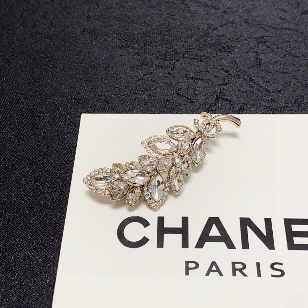 logo brooch