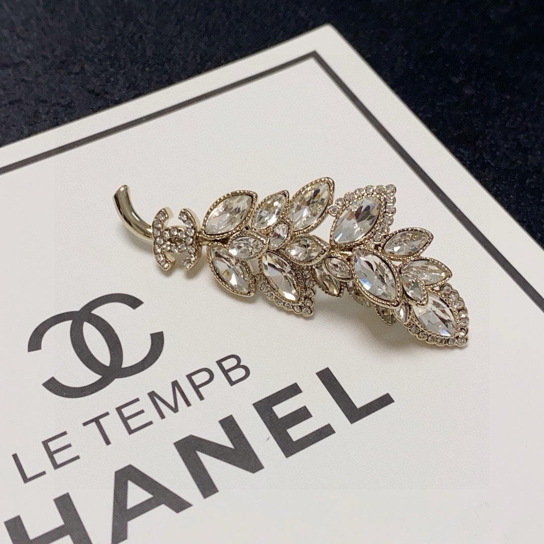 logo brooch