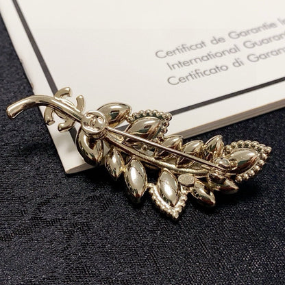 logo brooch